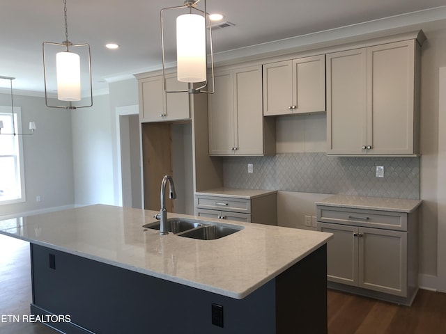 85 Royal Troon Cir, Oak Ridge, TN 37830 - kitchen featuring light stone countertops, crown molding, decorative backsplash, a center island with sink, and dark wood-style flooring