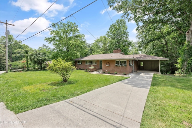 386 E Dr, Oak Ridge, TN 37830 - ranch-style home featuring concrete driveway, a chimney, brick siding, a front yard, and an attached carport