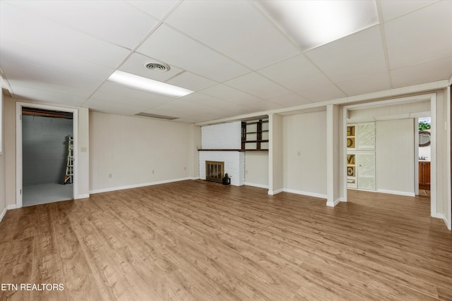 386 E Dr, Oak Ridge, TN 37830 - unfurnished living room with a paneled ceiling, light wood-type flooring, and a fireplace