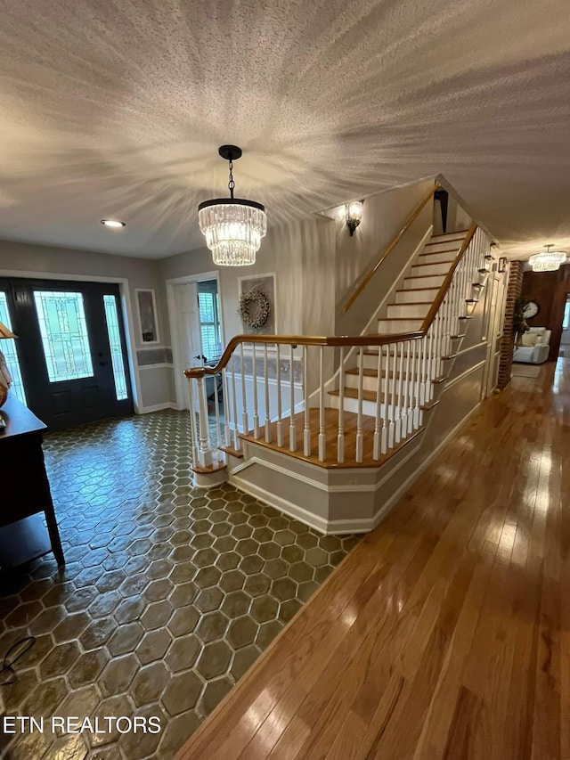 242 Adams Ln, Jellico, TN 37762 - foyer with a chandelier, stairway, and a textured ceiling