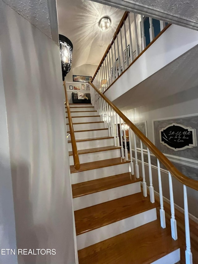 242 Adams Ln, Jellico, TN 37762 - staircase featuring lofted ceiling and wood finished floors