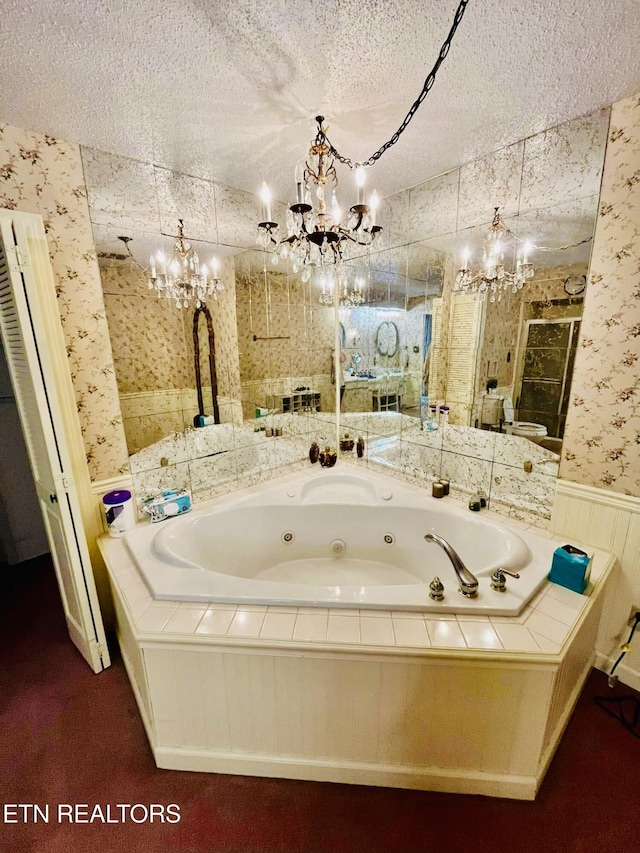 242 Adams Ln, Jellico, TN 37762 - bathroom with a chandelier, wallpapered walls, a whirlpool tub, a textured ceiling, and a wainscoted wall