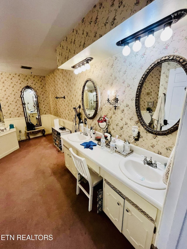 242 Adams Ln, Jellico, TN 37762 - full bathroom featuring wallpapered walls, wainscoting, and double vanity