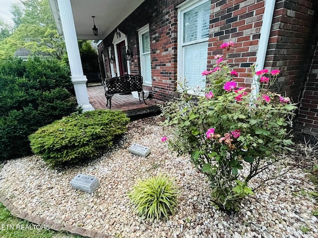 242 Adams Ln, Jellico, TN 37762 - view of side of home featuring a porch and brick siding