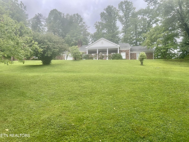 242 Adams Ln, Jellico, TN 37762 - view of grassy yard featuring a sunroom