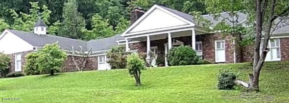 242 Adams Ln, Jellico, TN 37762 - view of front of house with a front lawn and a chimney