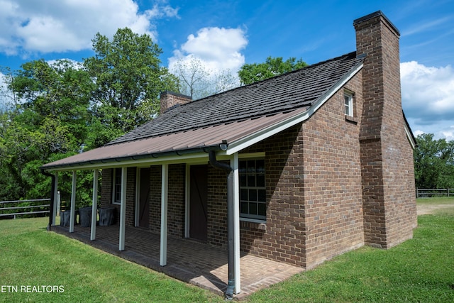 2590 Day Rd, Strawberry Plains, TN 37871 - view of side of home featuring a chimney, brick siding, and a metal roof