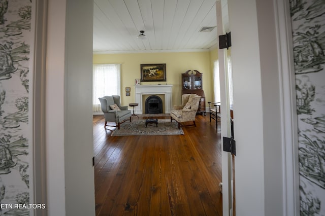2590 Day Rd, Strawberry Plains, TN 37871 - living area featuring a fireplace with raised hearth, ornamental molding, dark wood-style flooring, and wooden ceiling