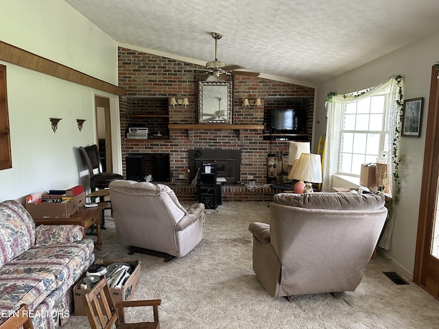 165 Bud Hatmaker Ln, Lafollette, TN 37766 - living area with lofted ceiling, a textured ceiling, carpet floors, ceiling fan, and a brick fireplace
