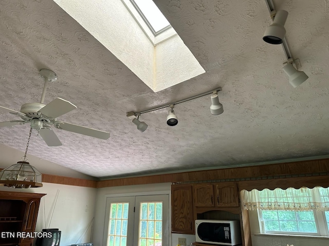 165 Bud Hatmaker Ln, Lafollette, TN 37766 - detailed view of white microwave, a ceiling fan, a skylight, and a textured ceiling