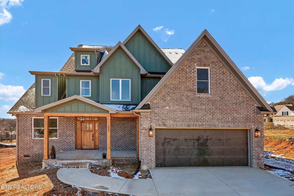835 Anchor Vista Rd, Knoxville, TN 37934 - view of front of home with board and batten siding, brick siding, concrete driveway, and an attached garage