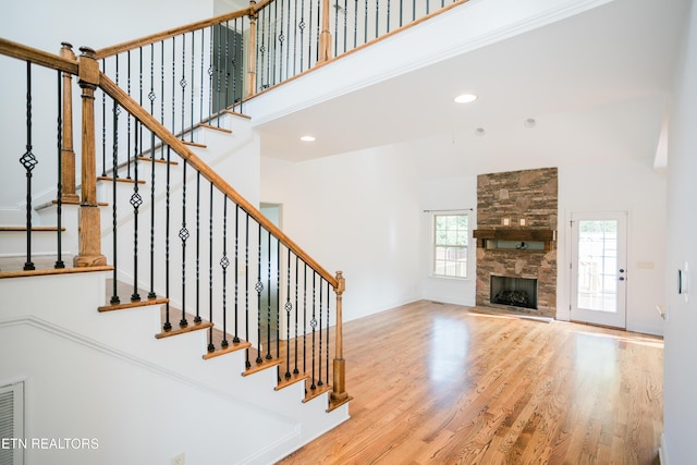 7481 Nightfall Cir, Ooltewah, TN 37363 - stairway with a high ceiling, wood finished floors, a fireplace, and recessed lighting