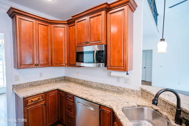 7481 Nightfall Cir, Ooltewah, TN 37363 - kitchen with stainless steel appliances, light stone countertops, hanging light fixtures, and brown cabinetry