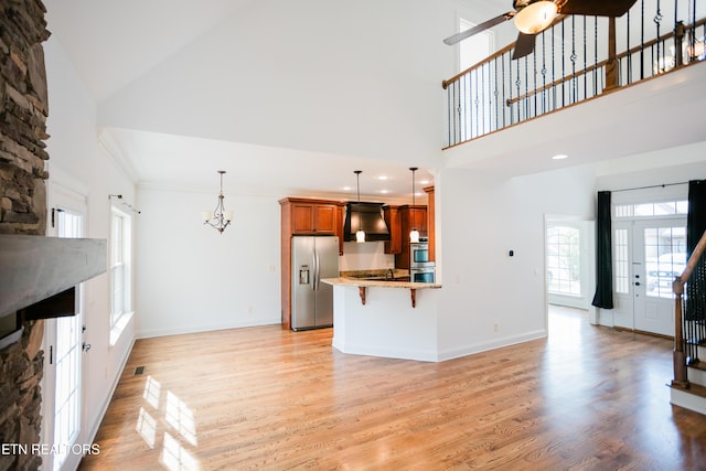 7481 Nightfall Cir, Ooltewah, TN 37363 - unfurnished living room with high vaulted ceiling, light wood finished floors, a ceiling fan, a chandelier, and recessed lighting