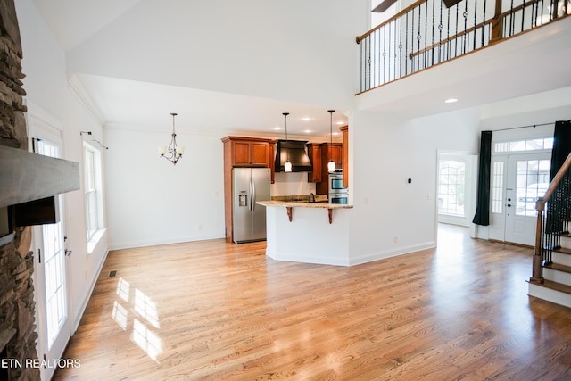 7481 Nightfall Cir, Ooltewah, TN 37363 - unfurnished living room with plenty of natural light, french doors, light wood finished floors, recessed lighting, and a chandelier