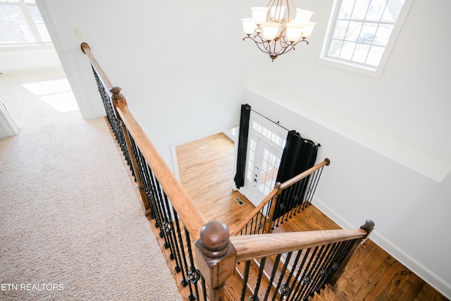 7481 Nightfall Cir, Ooltewah, TN 37363 - stairway featuring a chandelier and wood finished floors