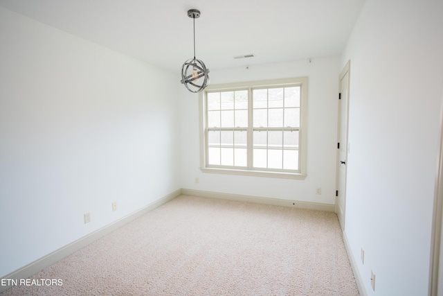 7481 Nightfall Cir, Ooltewah, TN 37363 - spare room with carpet flooring and a chandelier