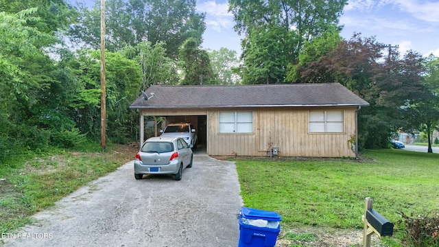 100 Nasson Ln, Oak Ridge, TN 37830 - view of front facade with asphalt driveway, a front lawn, a carport, and roof with shingles