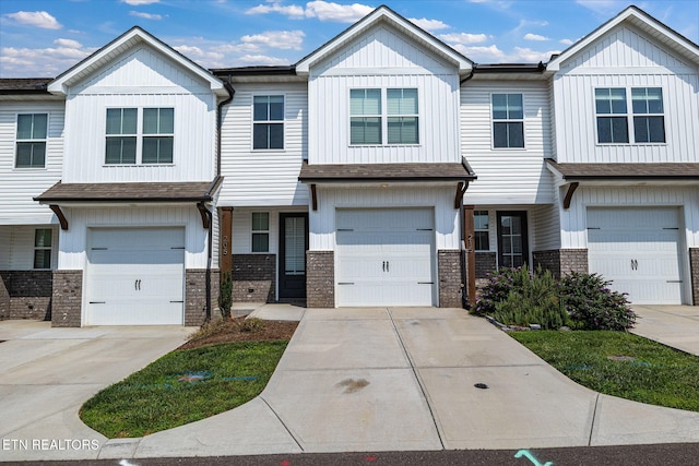 205 Harper Village Way, Lenoir City, TN 37771 - townhome / multi-family property with brick siding, concrete driveway, and a garage