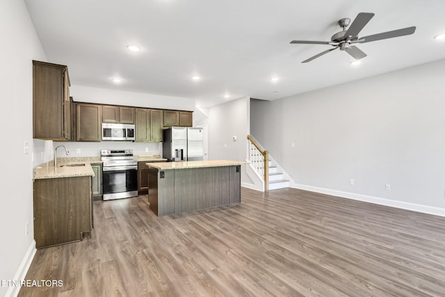 205 Harper Village Way, Lenoir City, TN 37771 - kitchen featuring appliances with stainless steel finishes, a center island, wood finished floors, a ceiling fan, and recessed lighting