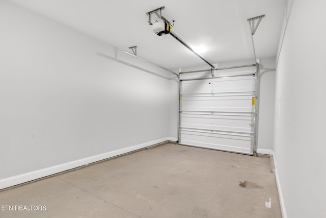 205 Harper Village Way, Lenoir City, TN 37771 - garage featuring a garage door opener and baseboards