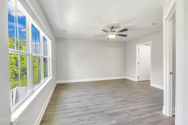 205 Harper Village Way, Lenoir City, TN 37771 - spare room with plenty of natural light, ceiling fan, wood finished floors, and a smoke detector