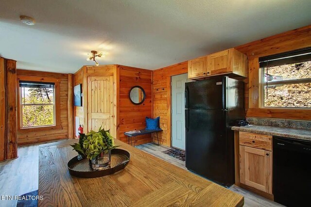 920 Falcon View Way, Sevierville, TN 37862 - kitchen featuring black appliances, light wood finished floors, wood walls, and dark countertops