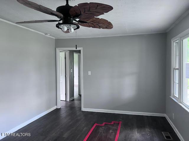 7832 Brickyard Rd, Powell, TN 37849 - empty room with ceiling fan, crown molding, healthy amount of natural light, and dark wood-style floors