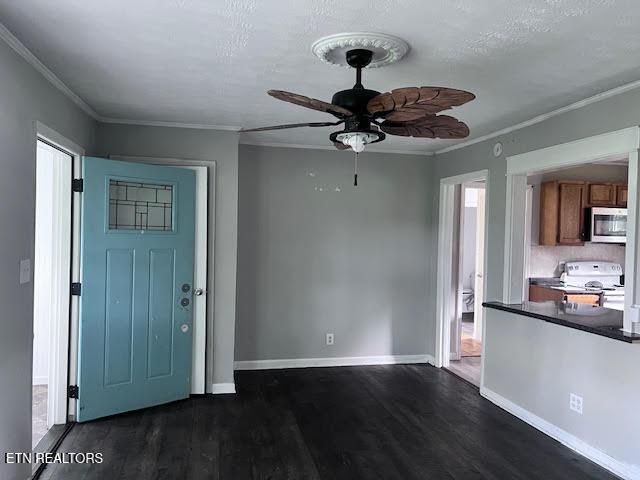 7832 Brickyard Rd, Powell, TN 37849 - entrance foyer with dark wood finished floors, a ceiling fan, ornamental molding, and baseboards