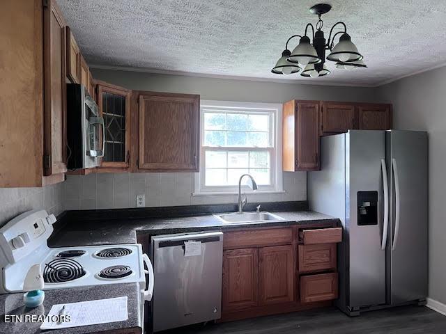 7832 Brickyard Rd, Powell, TN 37849 - kitchen with appliances with stainless steel finishes, a sink, a chandelier, a textured ceiling, and wood finished floors