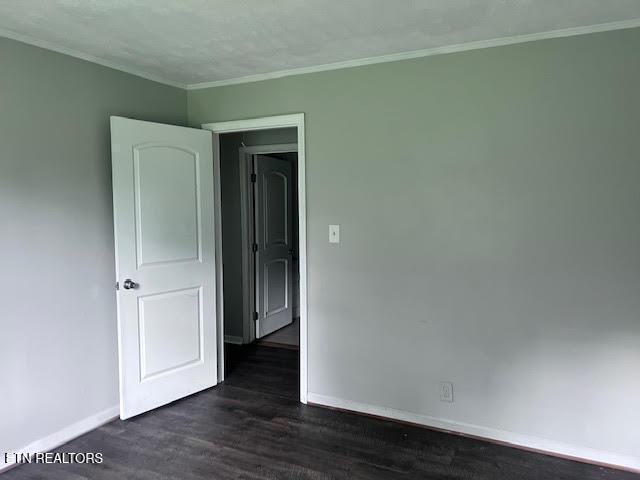 7832 Brickyard Rd, Powell, TN 37849 - spare room with baseboards, dark wood finished floors, and ornamental molding