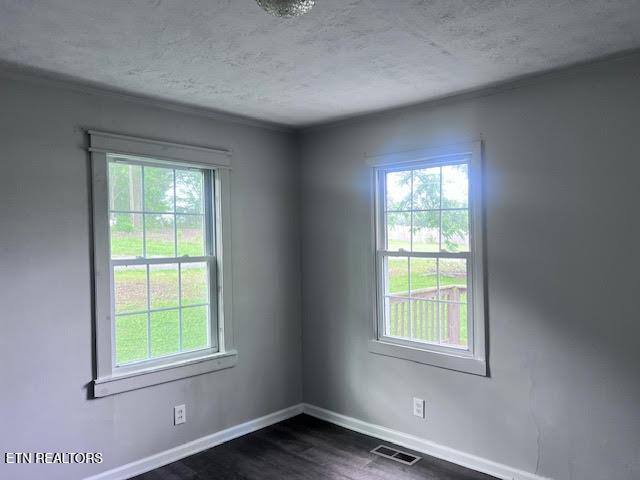 7832 Brickyard Rd, Powell, TN 37849 - empty room with a textured ceiling, baseboards, and dark wood-style floors