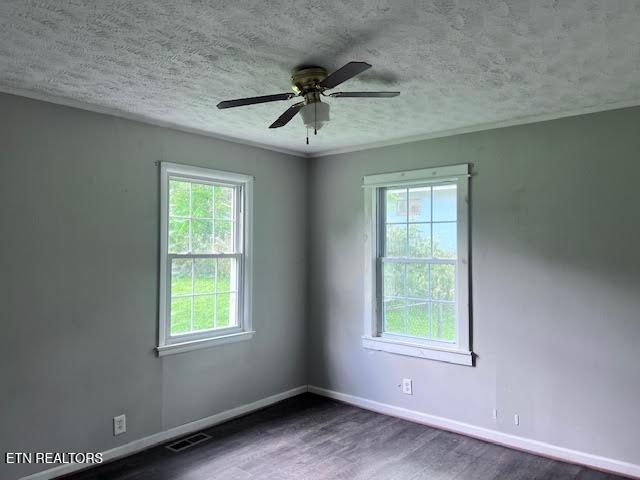 7832 Brickyard Rd, Powell, TN 37849 - spare room featuring wood finished floors, baseboards, a ceiling fan, and a textured ceiling