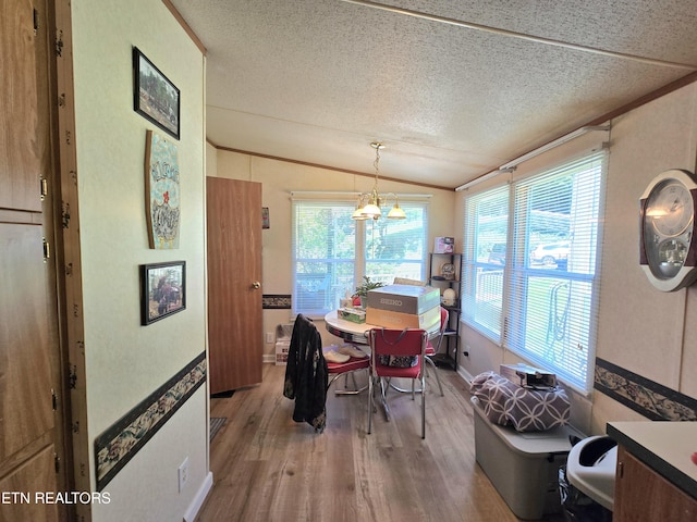 417 Ely Town Rd, Dryden, VA 24243 - dining space featuring wood finished floors, vaulted ceiling, and a textured ceiling