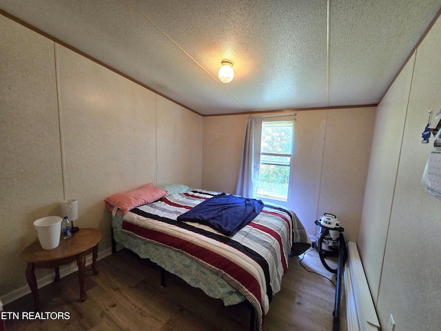 417 Ely Town Rd, Dryden, VA 24243 - bedroom featuring wood finished floors, a textured ceiling, baseboard heating, and ornamental molding