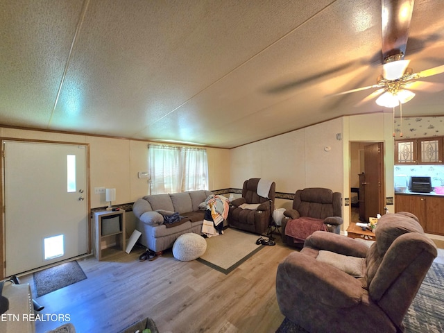 417 Ely Town Rd, Dryden, VA 24243 - living room with light wood-style flooring, a textured ceiling, vaulted ceiling, and ceiling fan