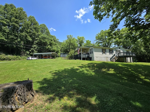417 Ely Town Rd, Dryden, VA 24243 - view of grassy yard with stairs, a detached carport, and a wooden deck