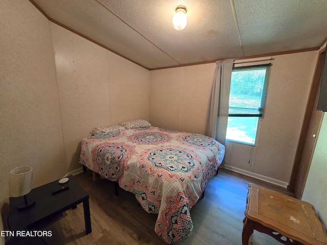 417 Ely Town Rd, Dryden, VA 24243 - bedroom featuring lofted ceiling, a textured ceiling, and wood finished floors