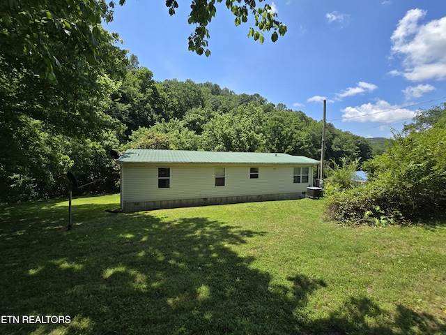 417 Ely Town Rd, Dryden, VA 24243 - rear view of property featuring a yard, a view of trees, central air condition unit, and metal roof