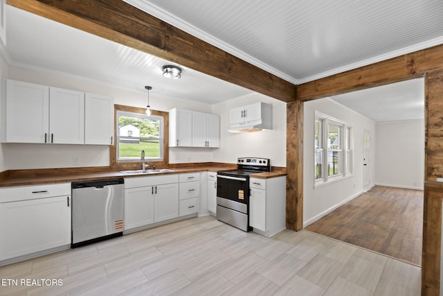 2504 Larkwood Ln, Knoxville, TN 37921 - kitchen with appliances with stainless steel finishes, under cabinet range hood, white cabinets, butcher block counters, and crown molding