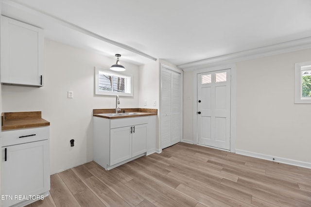 2504 Larkwood Ln, Knoxville, TN 37921 - kitchen with butcher block countertops, light wood-style flooring, white cabinets, and pendant lighting
