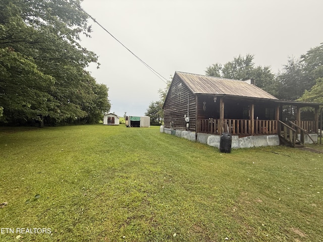 227 Bart Woolum, Lancing, TN 37770 - view of property exterior with a shed, a yard, and a metal roof