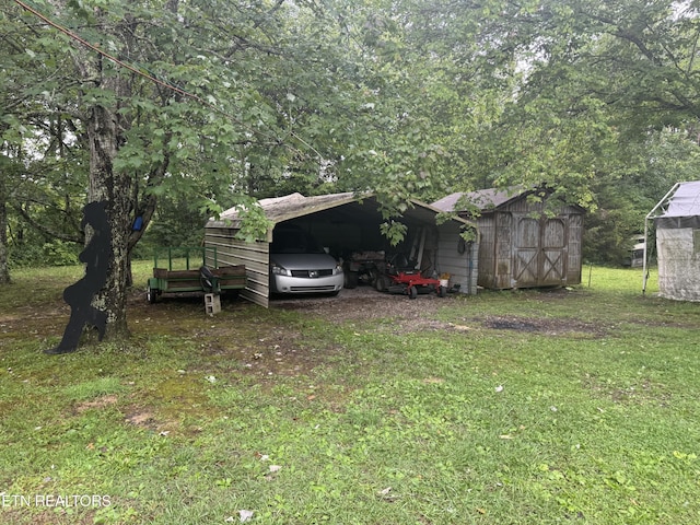 227 Bart Woolum, Lancing, TN 37770 - view of grassy yard with a storage unit and a carport