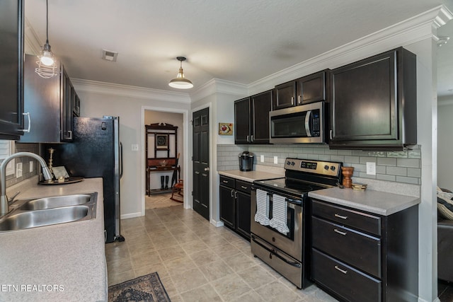 8431 Vessel Ln, Powell, TN 37849 - kitchen with appliances with stainless steel finishes, light countertops, backsplash, ornamental molding, and pendant lighting