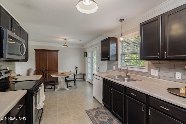 8431 Vessel Ln, Powell, TN 37849 - kitchen featuring appliances with stainless steel finishes, light countertops, pendant lighting, and crown molding