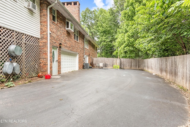 314 Longview Dr, Wartburg, TN 37887 - view of property exterior featuring an attached garage, asphalt driveway, a chimney, and brick siding