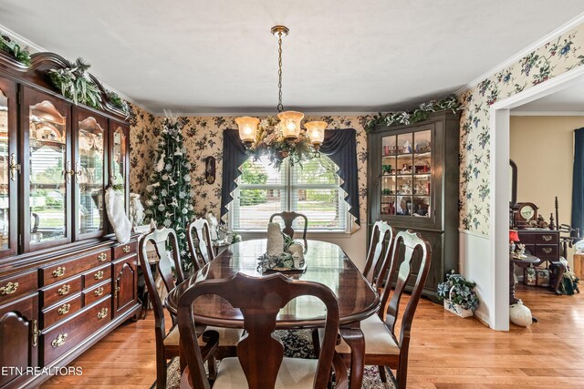 314 Longview Dr, Wartburg, TN 37887 - dining area featuring wallpapered walls, a chandelier, ornamental molding, light wood-style flooring, and wainscoting