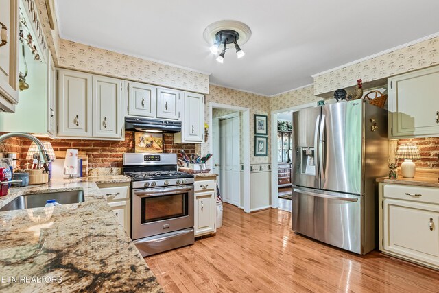 314 Longview Dr, Wartburg, TN 37887 - kitchen with stainless steel appliances, under cabinet range hood, ornamental molding, light wood-style floors, and wallpapered walls