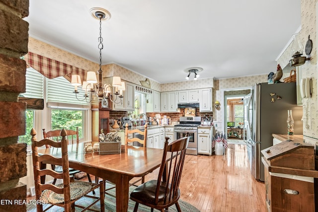 314 Longview Dr, Wartburg, TN 37887 - dining room with wallpapered walls, a chandelier, light wood-style flooring, and crown molding