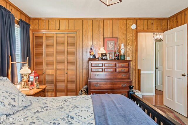 314 Longview Dr, Wartburg, TN 37887 - bedroom with a closet, wooden walls, crown molding, and a chandelier